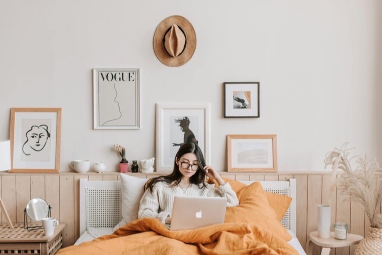 A styled bedroom with framed prints and home decor