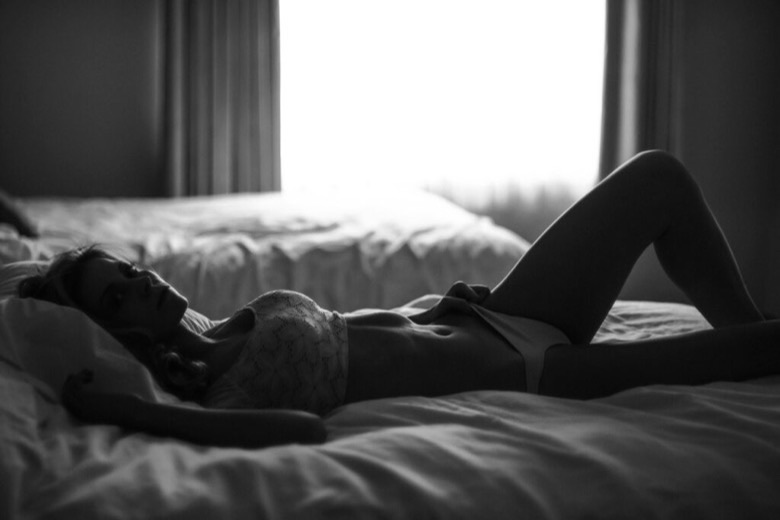 A lingerie product shot in a bedroom setting