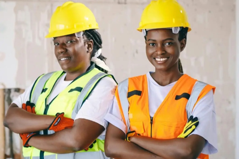 Two workers in high-visibility vests and hard hats